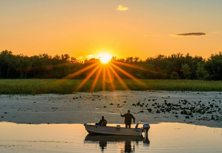Angler fishing at sunset on the water near Lake LaCroix in Bay St. Louis, MS