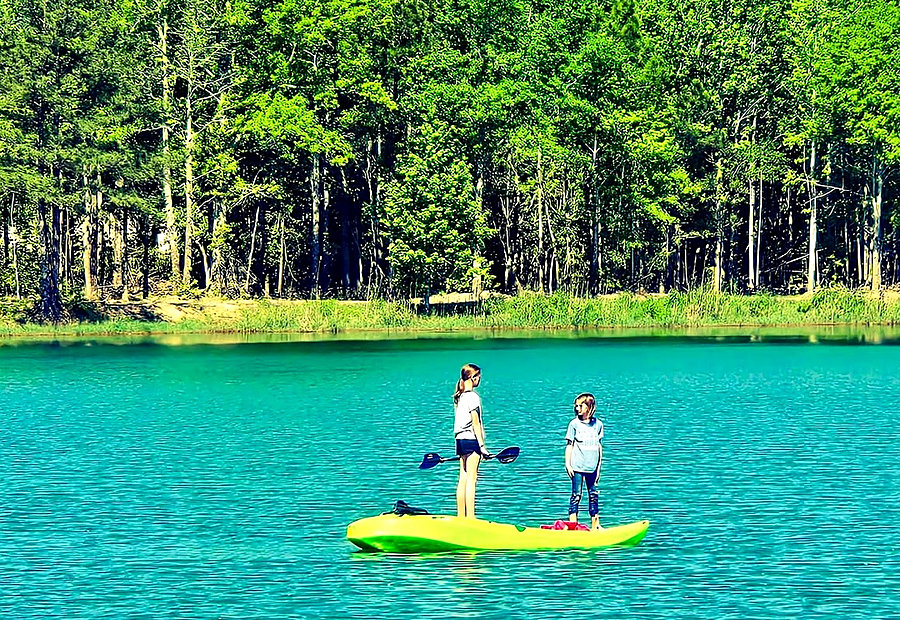 Paddleboards lined up on the beach at Lake LaCroix RV Resort in Bay St. Louis