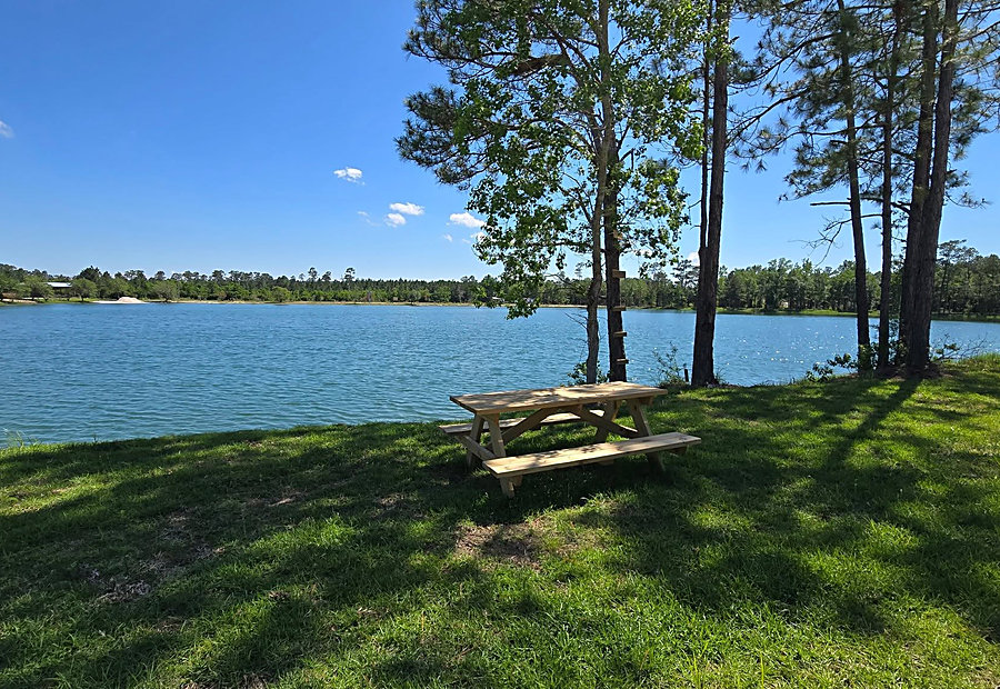 Family picnic by the water at Lake LaCroix RV Resort in Bay St. Louis
