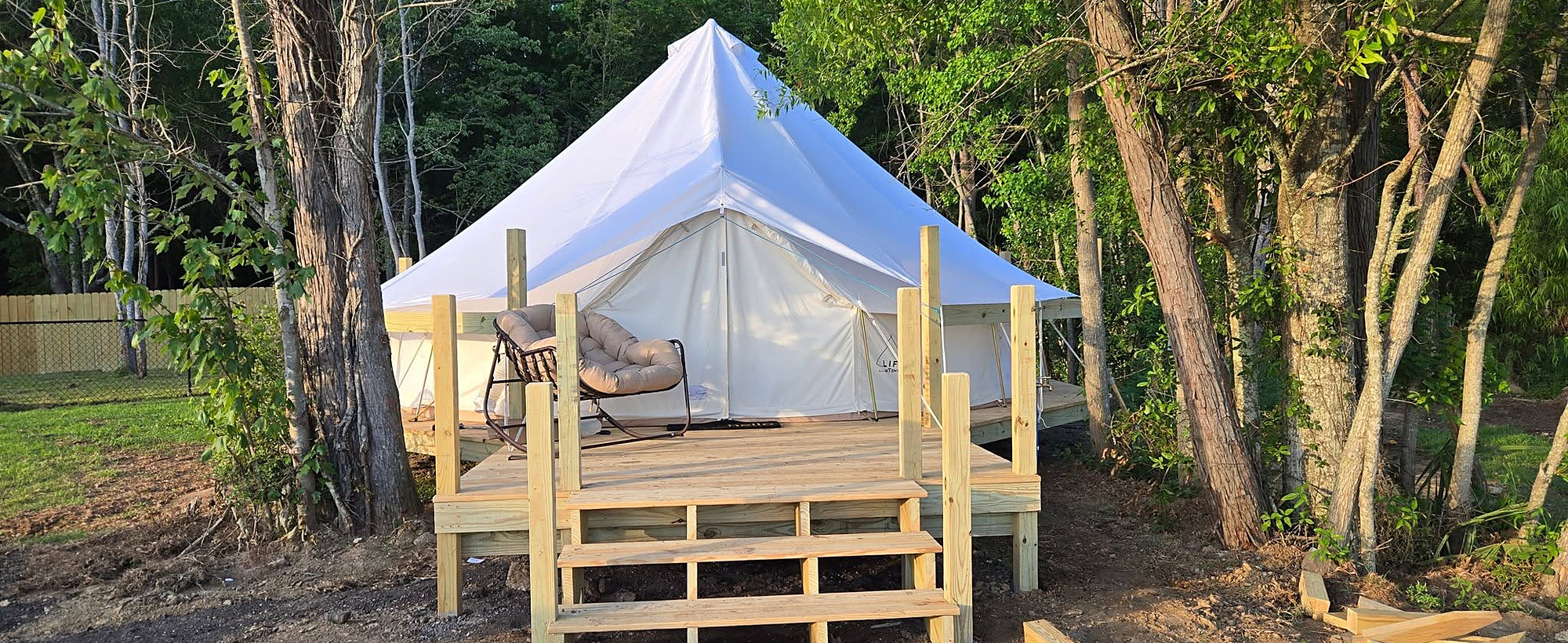Lakeside glamping tent with deck at Lake LaCroix RV Resort in Bay St. Louis