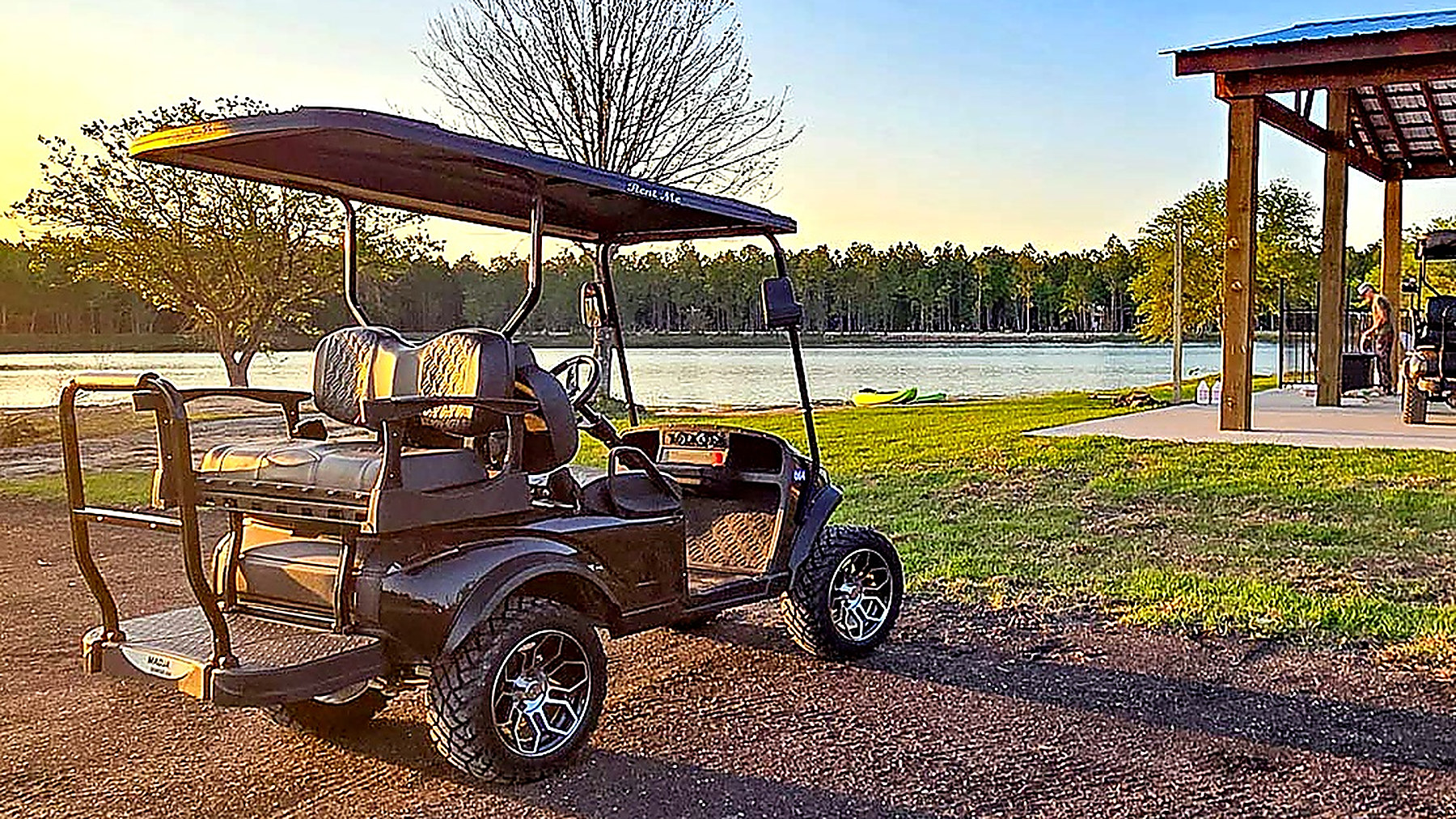 Golf cart cruising past lakeside RV sites at Lake LaCroix in Bay St. Louis