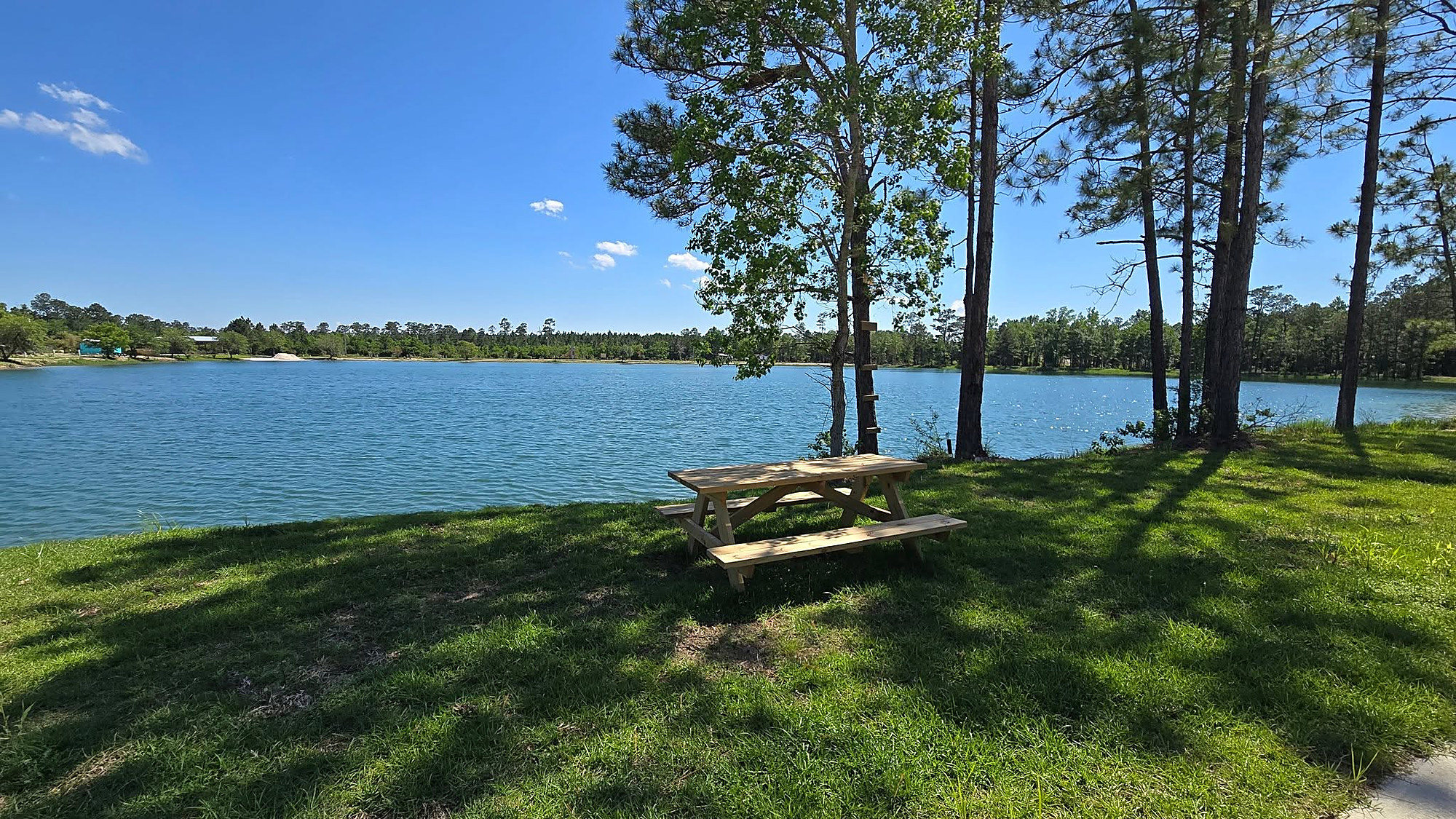 A lakeside picnic and dock area at Lake LaCroix RV Resort, a fishing basecamp in Bay St. Louis, MS