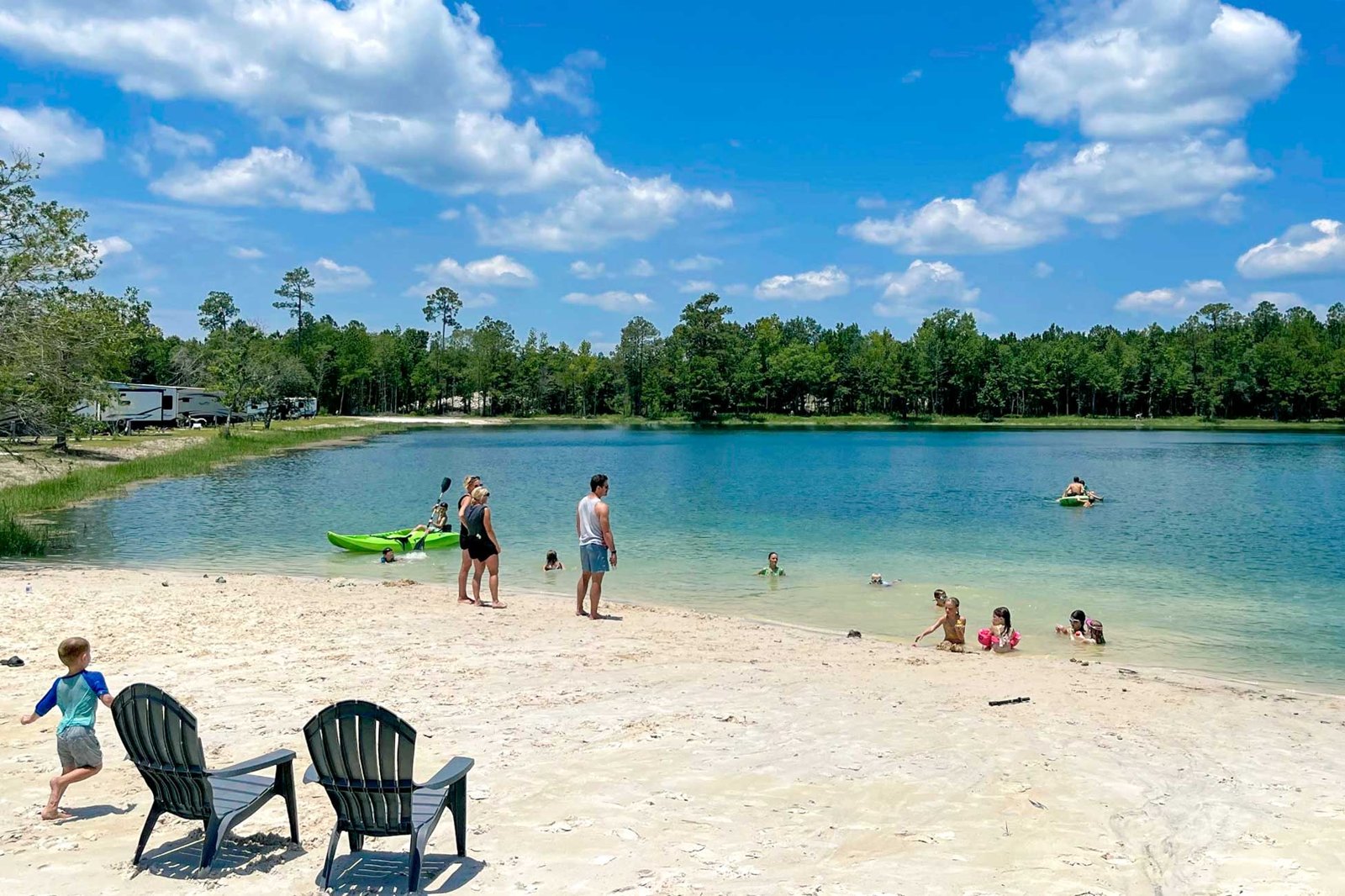 Families swimming at the sandy freshwater beach at Lake LaCroix