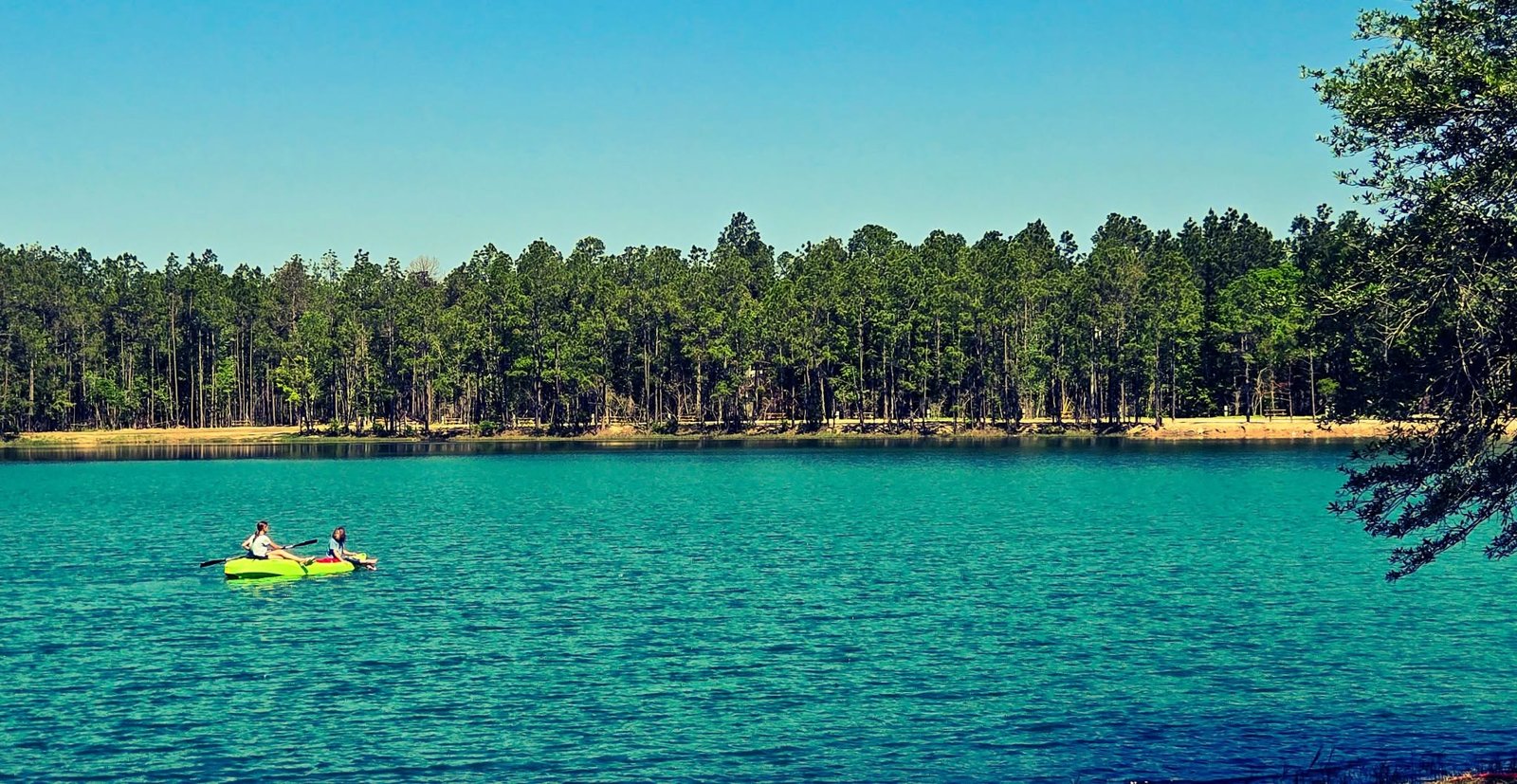 Kayaking across the vivid turquoise spring-fed lake