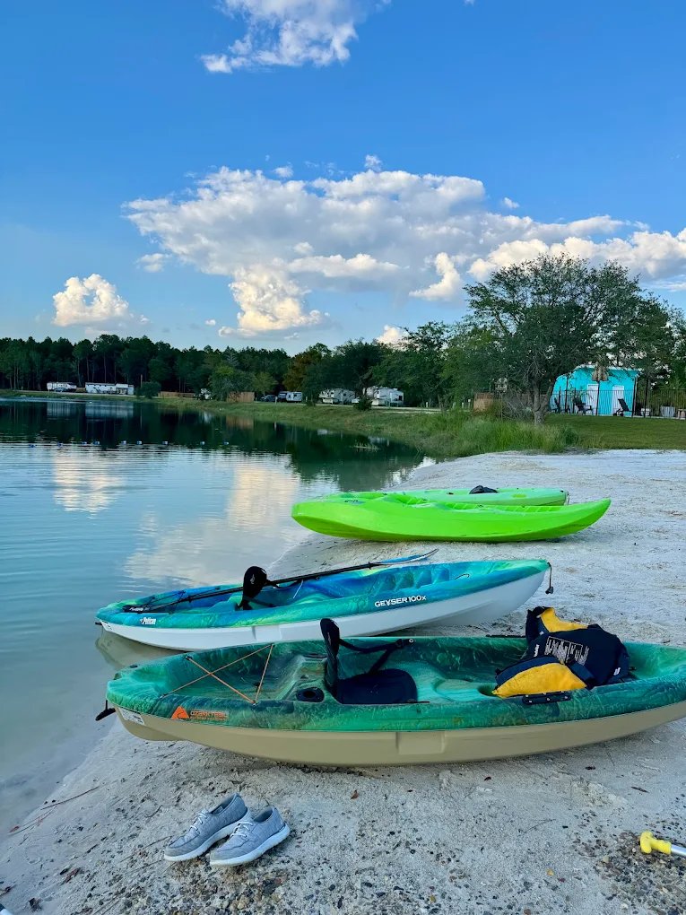 Kayaks resting on the sandy beach by the lake at Lake LaCroix