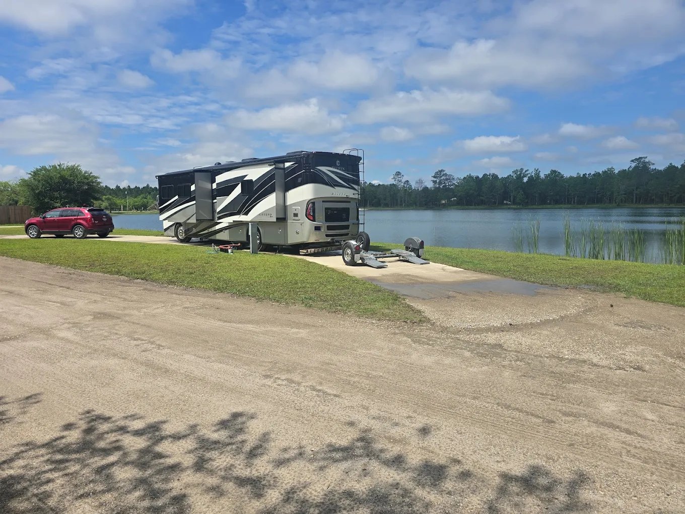Fifth-wheel RV set up at a waterfront site at Lake LaCroix in Bay St. Louis