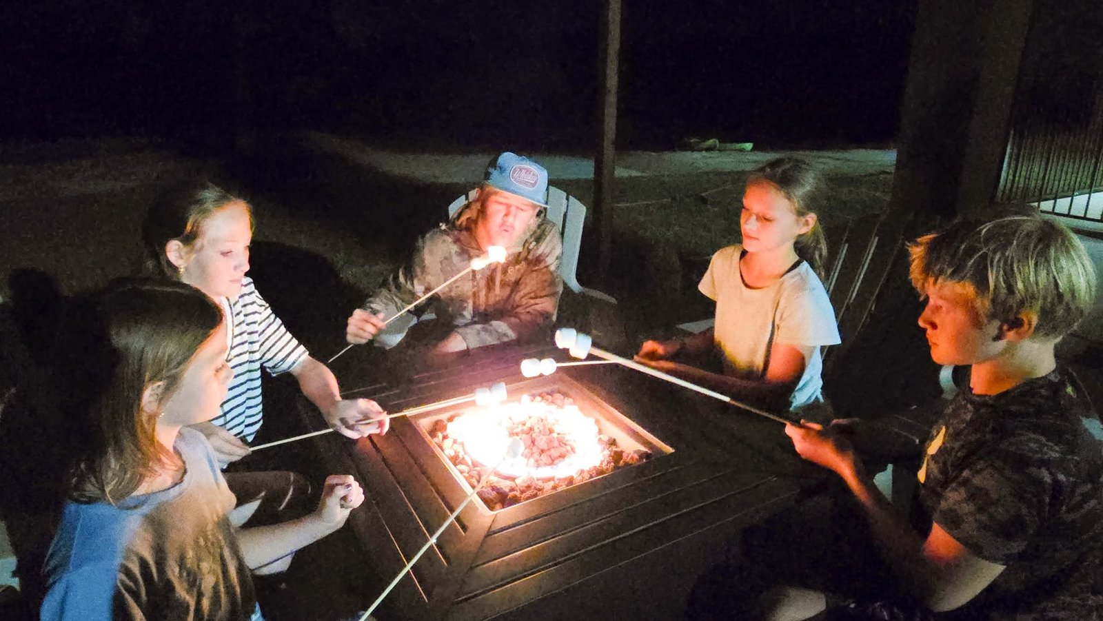 Kids making s'mores around the campfire at Lake LaCroix