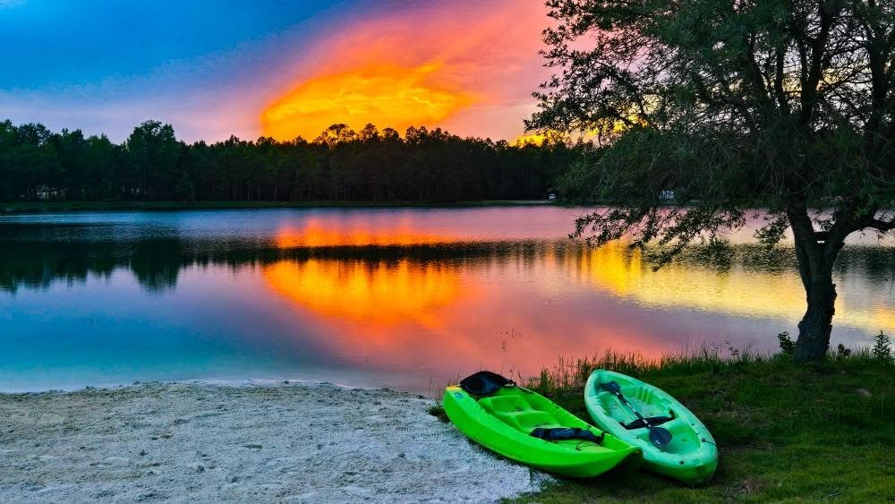 Sunset over the lake with kayaks on the beach at Lake LaCroix