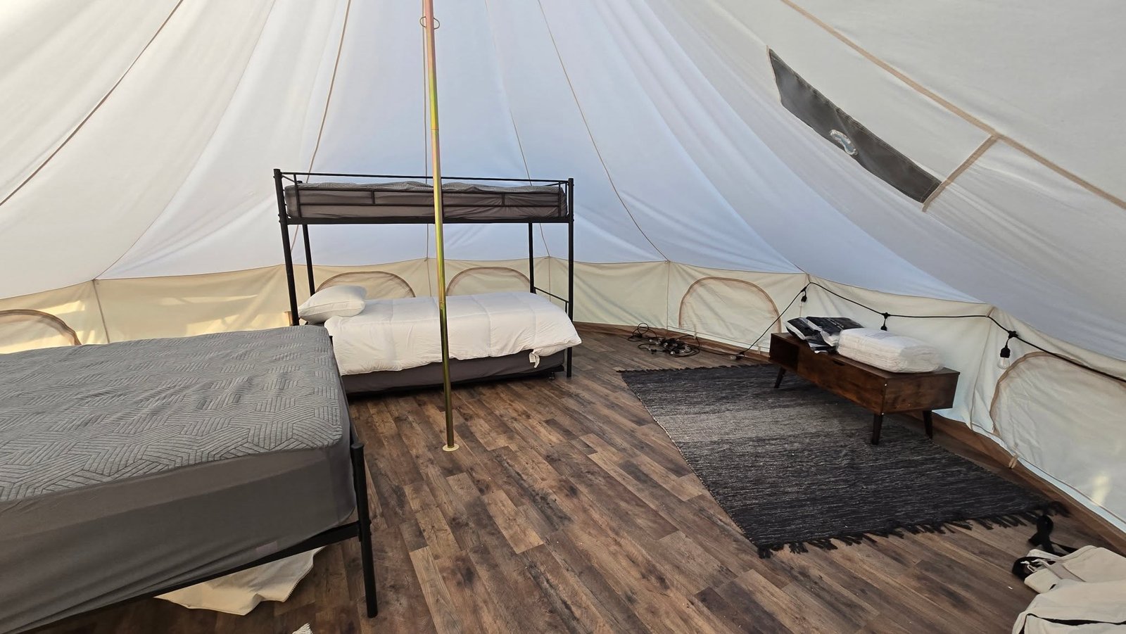 Cozy furnished interior of a glamping bell tent at Lake LaCroix RV Resort