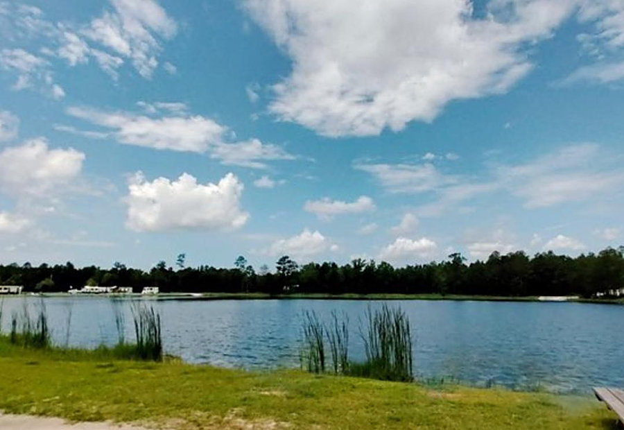 Lakefront RV site with a picnic table looking across the water at Lake LaCroix RV Resort