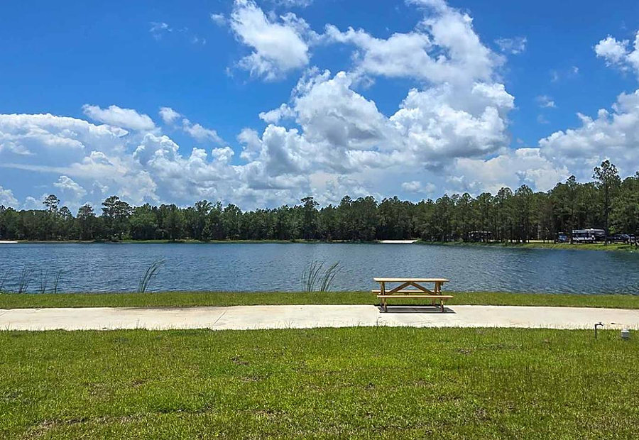 Waterfront pull-through RV site with concrete pad and picnic table on the lake at Lake LaCroix RV Resort